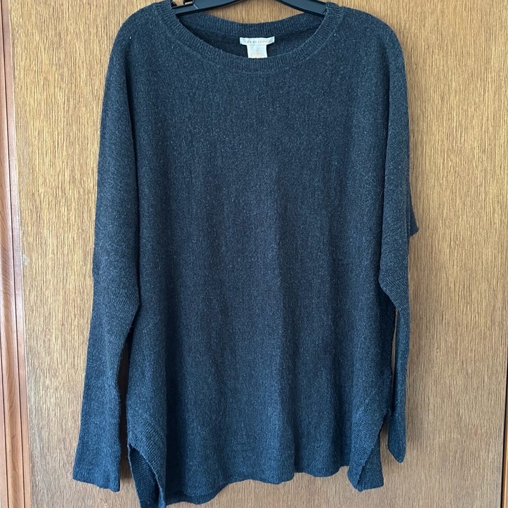 This sweater is actually charcoal, size L, Very soft fabric, acrylic. Side slits